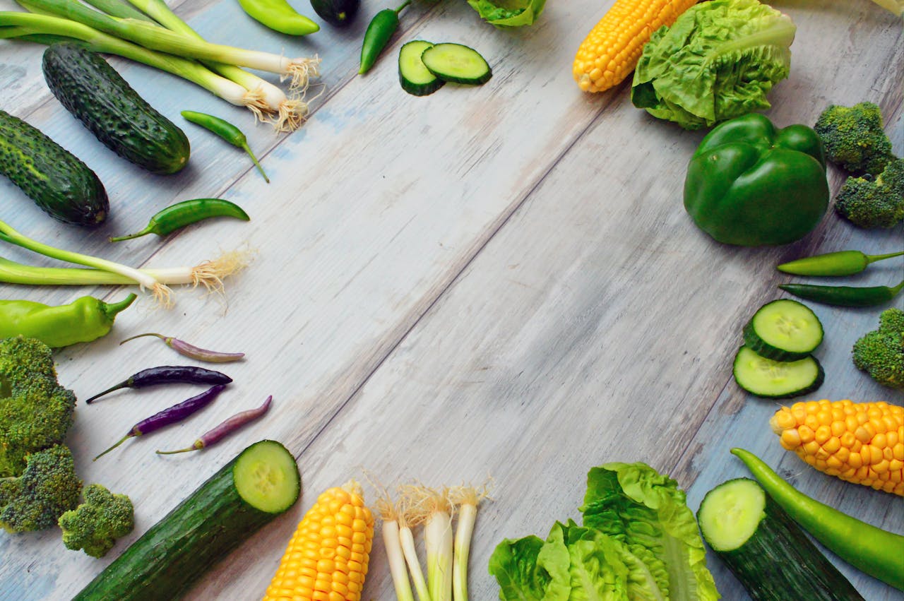 about-01 An assortment of fresh vegetables on a wooden table, perfect for healthy cooking.